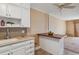 Kitchen with butcher block island and white cabinets at 690 S Alton Way # 1C, Denver, CO 80247