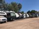 Community RV parking lot with various RVs at 690 S Alton Way # 1C, Denver, CO 80247