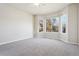 Bright bedroom with bay window and neutral carpeting at 1025 Bramblewood Dr, Castle Pines, CO 80108