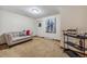 Comfortable basement sitting area with sofa and wine cart at 3081 W 151St Ct, Broomfield, CO 80023