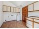 Bright laundry room with tile floors and built-in cabinets at 3081 W 151St Ct, Broomfield, CO 80023