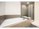 Relaxing bathroom with soaking tub and glass shower at 2001 Lincoln St # 1823, Denver, CO 80202