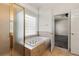 Main bathroom with a bathtub, shower, and access to a bedroom at 3942 Lazy K Dr, Castle Rock, CO 80104