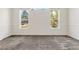 Well-lit bedroom featuring carpet flooring and two large windows at 3942 Lazy K Dr, Castle Rock, CO 80104