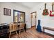 Home office with wood floors, two chairs, and a record player at 1893 Silverheels Dr, Larkspur, CO 80118