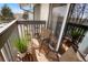 Small balcony with two chairs and a potted plant at 7525 W 62Nd Ave # 11, Arvada, CO 80003