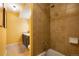 Brown tiled bathroom with a shower/tub combo and vanity at 7525 W 62Nd Ave # 11, Arvada, CO 80003