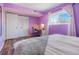 Purple bedroom with a queen bed, built-in closet, and a workspace at 7525 W 62Nd Ave # 11, Arvada, CO 80003