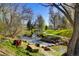 Peaceful creekside walking path with bridge at 7525 W 62Nd Ave # 11, Arvada, CO 80003