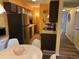 Kitchen with stainless steel appliances and view into dining area at 7525 W 62Nd Ave # 11, Arvada, CO 80003