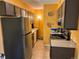 Galley kitchen with dark brown cabinets and stainless steel appliances at 7525 W 62Nd Ave # 11, Arvada, CO 80003