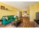 Living room with green couch and adjacent dining area at 7525 W 62Nd Ave # 11, Arvada, CO 80003