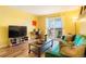 Living room with green couch, wood floors, and access to a balcony at 7525 W 62Nd Ave # 11, Arvada, CO 80003