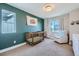 Charming Bedroom featuring a crib, armchair, and decorative wall art at 12855 Park Creek Way, Firestone, CO 80504