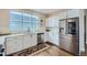 Modern kitchen with stainless steel appliances and white cabinets at 12855 Park Creek Way, Firestone, CO 80504