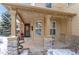 Inviting covered front porch with stone columns and comfortable seating at 3953 Blue Pine Cir, Highlands Ranch, CO 80126