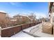 Private patio with a wood fence and covered furniture at 3953 Blue Pine Cir, Highlands Ranch, CO 80126