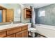 Main bathroom with bathtub, wood cabinets and hexagonal tile at 4720 W 37Th Ave # 29, Denver, CO 80212