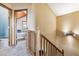 Upstairs hall with wood railing and carpet flooring at 4720 W 37Th Ave # 29, Denver, CO 80212