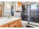 Bathroom with walk-in shower, wood vanity, and neutral tile at 4720 W 37Th Ave # 29, Denver, CO 80212