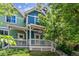 Colorful two-story townhome with front porch and landscaping at 4720 W 37Th Ave # 29, Denver, CO 80212