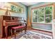 Inviting music room featuring a piano, ample natural light, and hardwood floors at 4720 W 37Th Ave # 29, Denver, CO 80212