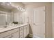 Modern bathroom with double vanity, a large mirror and shower at 462 Millwall Cir, Castle Pines, CO 80108