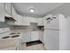 White kitchen features efficient layout, stove, and dishwasher at 2160 S Vaughn Way # 304C, Aurora, CO 80014