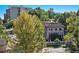 Exterior view of a charming house with a red tile roof and lush green trees at 801 N Pennsylvania St # 405, Denver, CO 80203