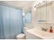 Clean bathroom with light blue shower curtain at 801 N Pennsylvania St # 405, Denver, CO 80203