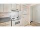 Bright kitchen features white cabinets and appliances at 801 N Pennsylvania St # 405, Denver, CO 80203