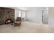 Living room with brick fireplace and comfy armchair at 801 N Pennsylvania St # 405, Denver, CO 80203