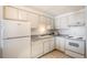 Bright kitchen featuring white cabinets and appliances at 801 N Pennsylvania St # 405, Denver, CO 80203