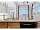 Kitchen features granite countertops, a double sink, and modern dishwasher at 15455 Canyon Rim Dr # 307, Englewood, CO 80112