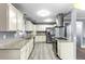 Stylish kitchen with white cabinets, granite countertops, and a stainless steel refrigerator at 119 S 8Th Ave, Brighton, CO 80601