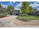 Mid-century modern home with a landscaped yard at 1440 S Dahlia St, Denver, CO 80222