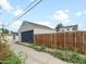 Detached garage with blue door and alley access at 4835 Shoshone St, Denver, CO 80221