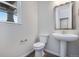 Clean and modern bathroom with pedestal sink and updated fixtures at 3442 N Gold Bug Ct, Aurora, CO 80019