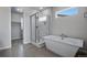 Bathroom featuring a soaking tub and walk-in shower at 3442 N Gold Bug Ct, Aurora, CO 80019