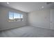 Bright bedroom with large window and neutral carpeting at 3442 N Gold Bug Ct, Aurora, CO 80019