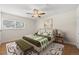 Bedroom with a bed, nightstands, and a ceiling fan at 8019 Wolff St # G, Westminster, CO 80031