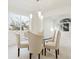 Bright dining room with glass table, beige chairs, and natural light at 8154 Lone Maple Ln, Lone Tree, CO 80124