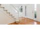 Hardwood floors, staircase, and white door in the home entryway at 8154 Lone Maple Ln, Lone Tree, CO 80124