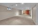 Finished basement with neutral carpet and track lighting at 7900 W Layton Ave # 911, Littleton, CO 80123