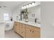 Modern bathroom with double vanity, soaking tub, and walk-in shower at 2316 Holly St, Denver, CO 80207