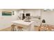 Modern kitchen with island, white cabinets, and stainless steel appliances at , Aurora, CO 80019