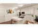 Modern kitchen with island, white cabinets, and stainless steel appliances at , Aurora, CO 80019