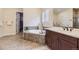 Elegant bathroom with soaking tub, walk-in shower, and double vanity at 14969 Elsinore Ave, Parker, CO 80134