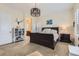 Bright bedroom featuring a king-size bed and ensuite bathroom access at 14969 Elsinore Ave, Parker, CO 80134