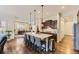 Modern kitchen with dark wood cabinets, quartz countertops, and an island at 14969 Elsinore Ave, Parker, CO 80134